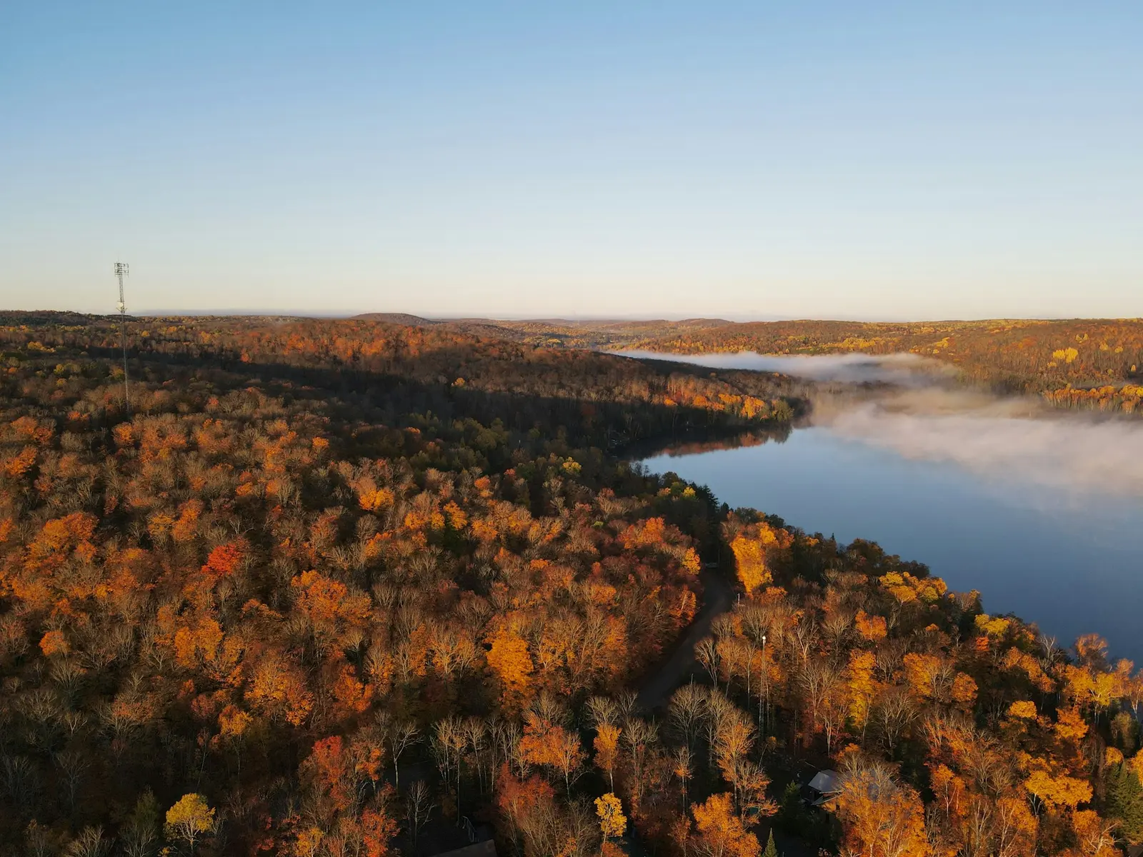Aerial view of autumn forest and a lake on rolling moraine country