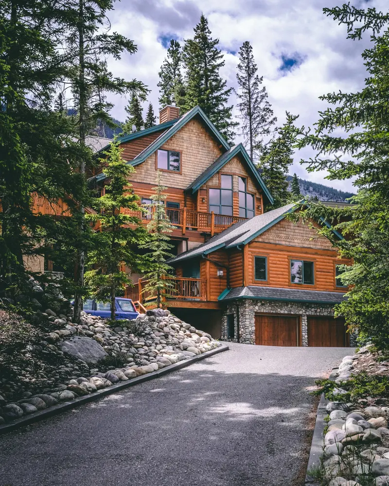 Timber house in a forested lot on a hillside