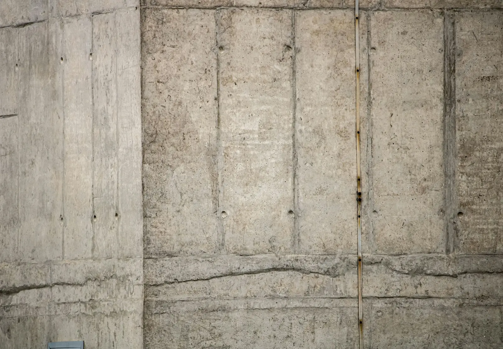 Poured concrete wall with visible crack lines