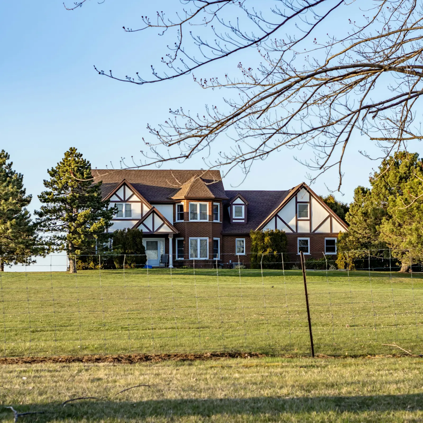 Large house on a wide lawn in early spring