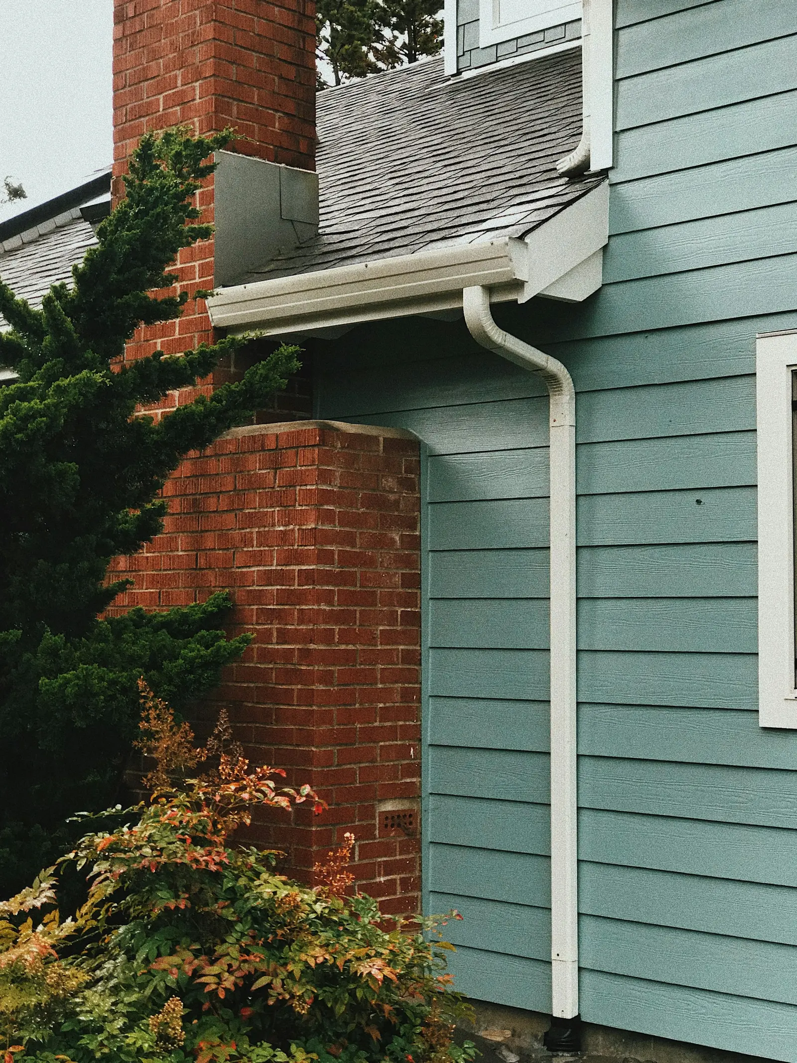 Downspout and gutter on the corner of a brick house