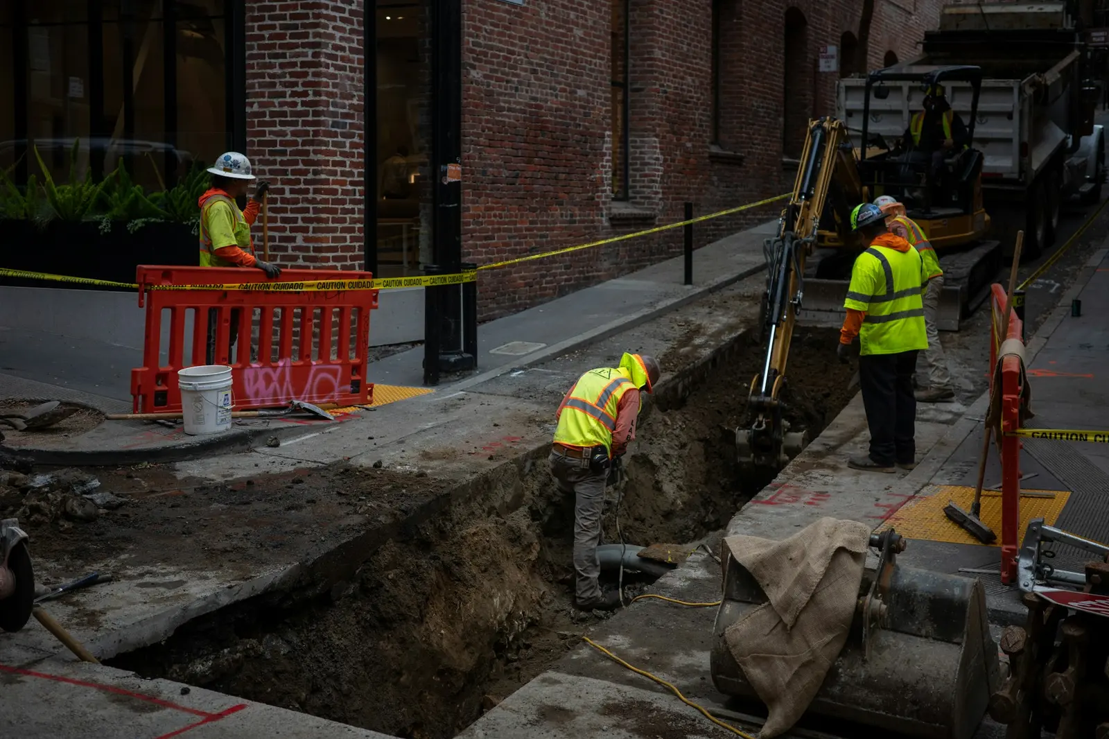 Crew working in an open trench in a residential street